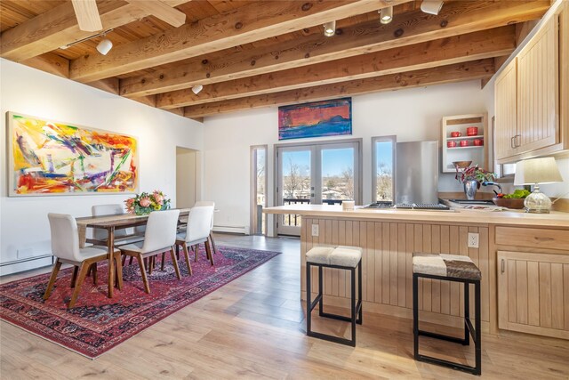 637 Alto St Unit A, Santa Fe, NM 87501 - kitchen with light wood-style floors, beamed ceiling, a peninsula, and a baseboard radiator