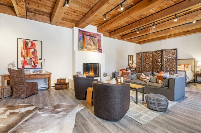 living room featuring a baseboard heating unit, track lighting, wooden ceiling, light hardwood / wood-style floors, and beamed ceiling