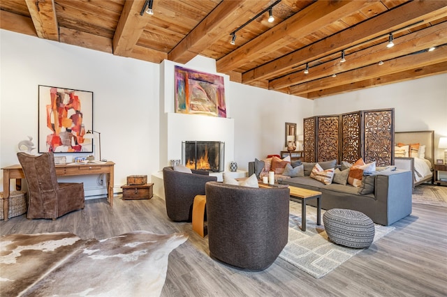 living room featuring a fireplace, hardwood / wood-style flooring, wood ceiling, track lighting, and beam ceiling