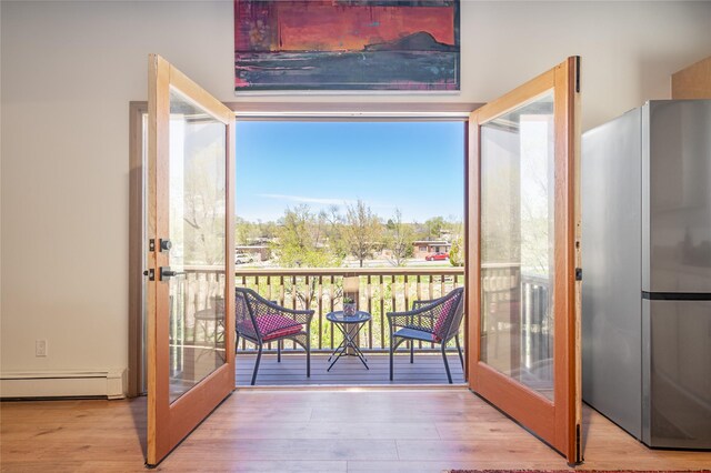 637 Alto St Unit A, Santa Fe, NM 87501 - doorway featuring baseboard heating, wood finished floors, and french doors