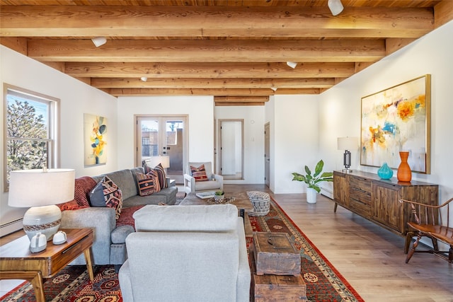 living room with beamed ceiling, french doors, and light wood-type flooring