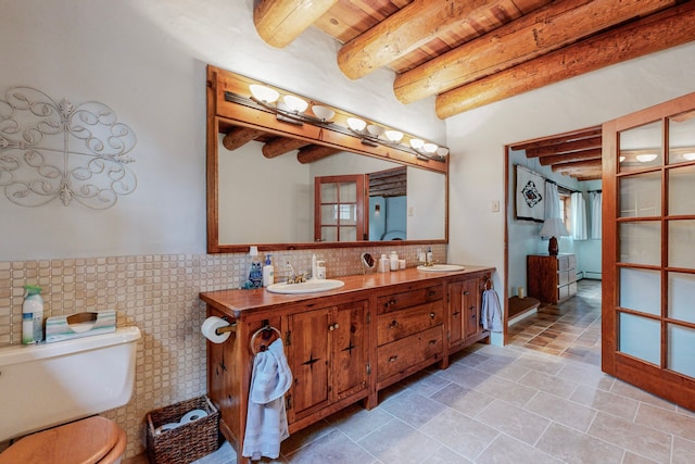 bathroom featuring wooden ceiling, beam ceiling, toilet, and vanity