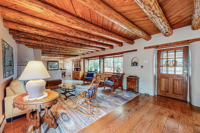 living room with wood-type flooring, wood ceiling, and beam ceiling