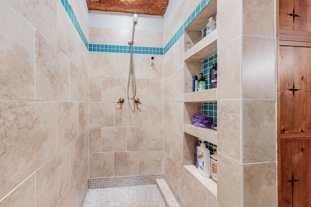 bathroom with a tile shower