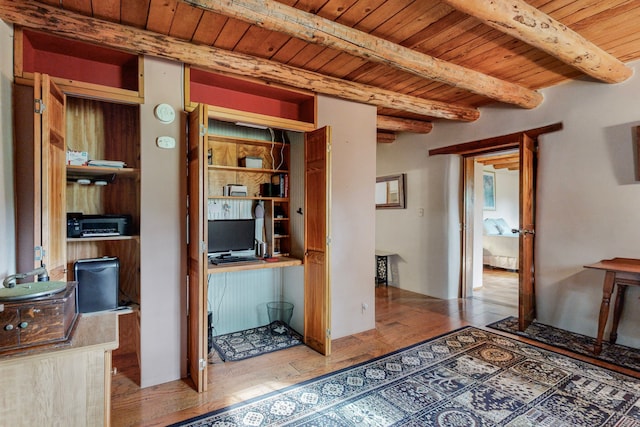 interior space with beamed ceiling, hardwood / wood-style flooring, and wooden ceiling