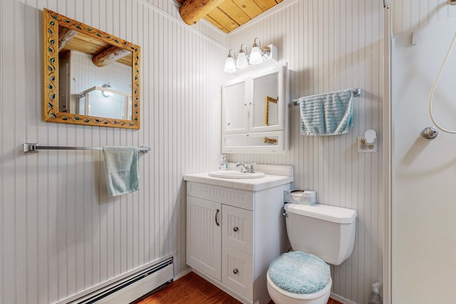 bathroom featuring vanity, a baseboard radiator, beam ceiling, hardwood / wood-style flooring, and toilet