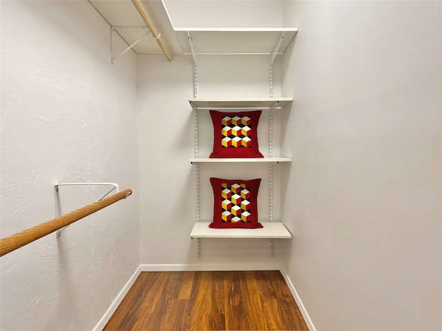 walk in closet featuring dark wood-type flooring