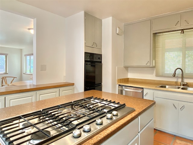 kitchen featuring sink, light tile patterned flooring, and stainless steel appliances