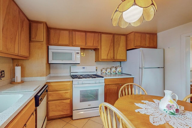 kitchen with light tile patterned flooring and white appliances