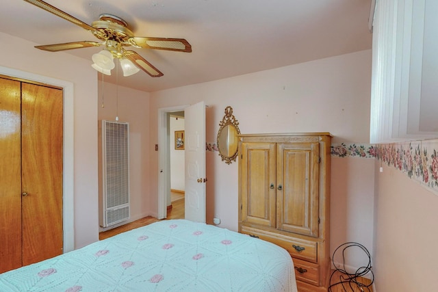 bedroom with ceiling fan and a closet