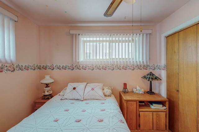 bedroom with ceiling fan and a closet