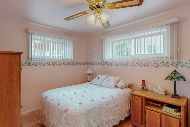 bedroom with light hardwood / wood-style flooring and ceiling fan