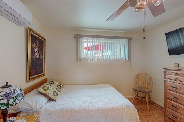 bedroom featuring ceiling fan, parquet floors, and a wall unit AC