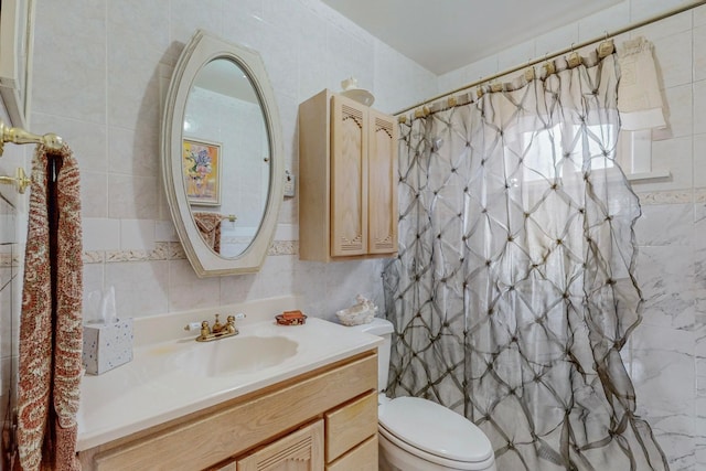 bathroom with vanity, tile walls, toilet, and curtained shower