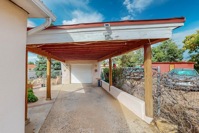 view of patio featuring a carport and a garage