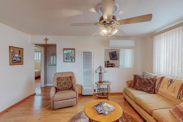 living room featuring a healthy amount of sunlight, ceiling fan, a wall unit AC, and light hardwood / wood-style flooring