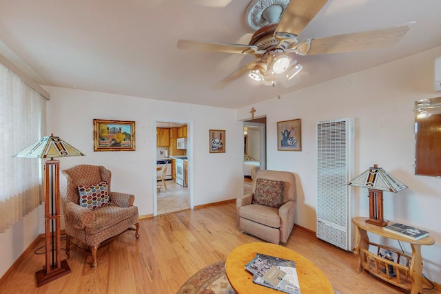 living area featuring ceiling fan and light wood-type flooring