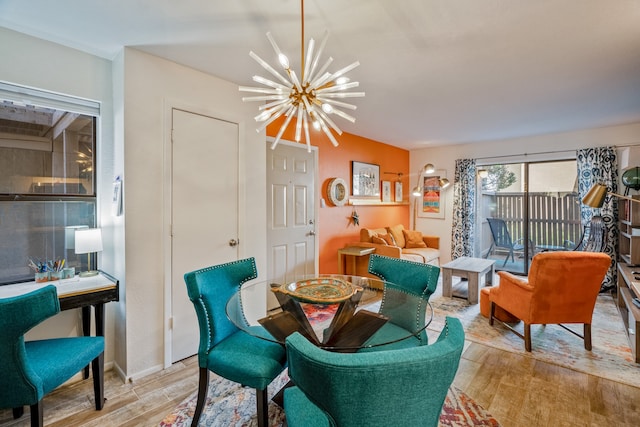 dining space with light hardwood / wood-style flooring and a notable chandelier