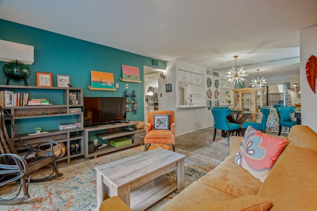 living room with a chandelier, hardwood / wood-style flooring, and sink