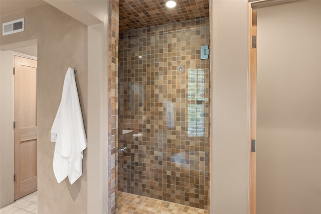 bathroom featuring a tile shower and tile patterned floors