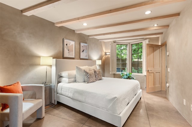 bedroom with concrete floors and beamed ceiling