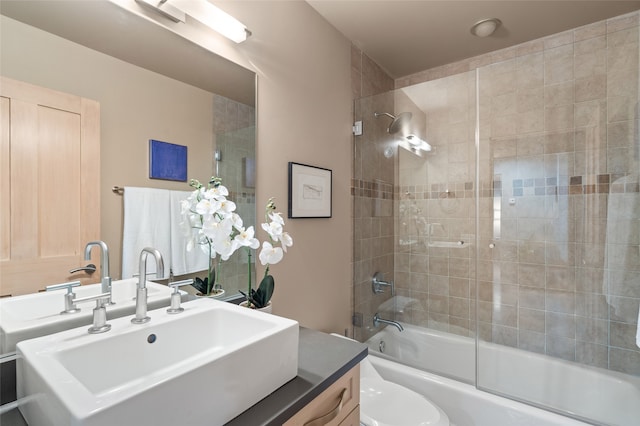 full bathroom featuring tiled shower / bath combo, vanity, and toilet