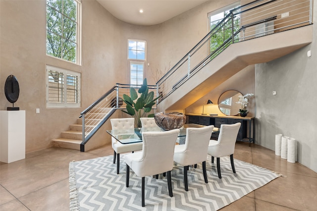 dining space featuring a towering ceiling