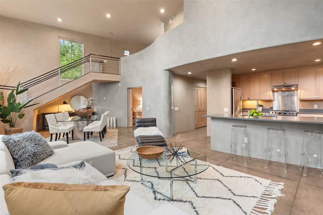 tiled living room featuring a high ceiling