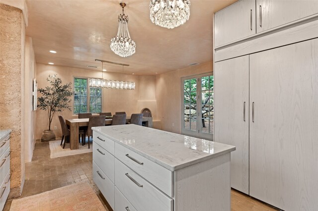 spacious closet featuring light wood-type flooring and a chandelier