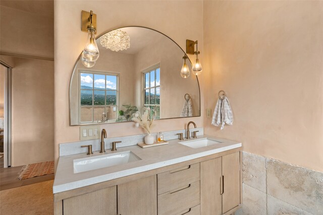 bathroom featuring vanity and tile walls