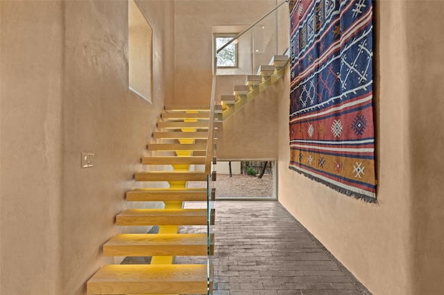 23 Lavadero Rd, Santa Fe, NM 87506 - stairway featuring a high ceiling and brick floor