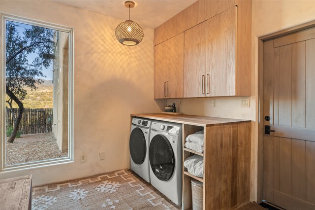 laundry room featuring cabinets and separate washer and dryer