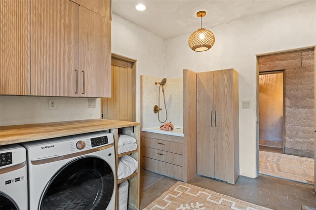 clothes washing area with washer and clothes dryer