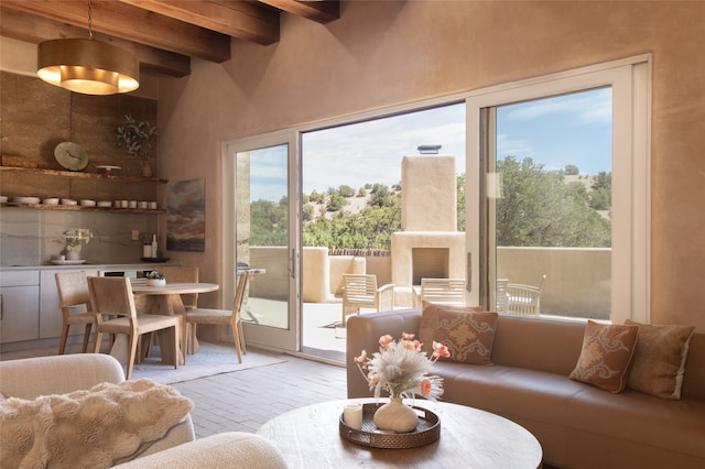 living room featuring beamed ceiling and light hardwood / wood-style flooring