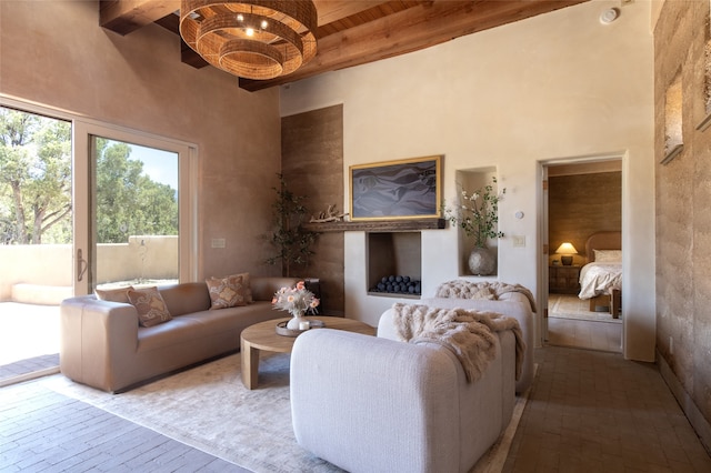 living room with beam ceiling and a high ceiling