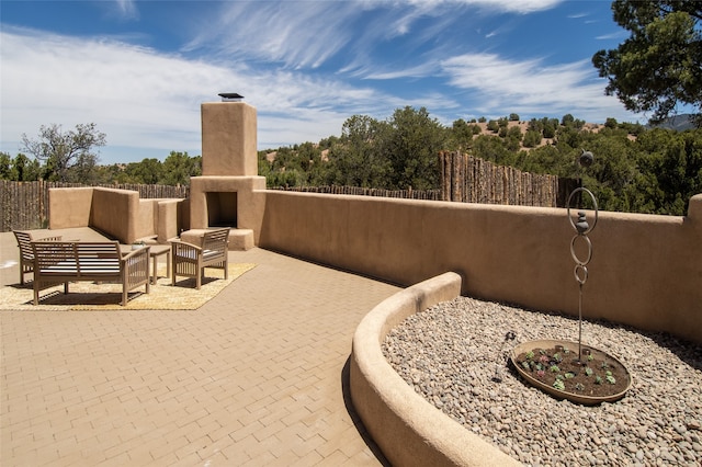 23 Lavadero Rd, Santa Fe, NM 87506 - view of patio / terrace with an outdoor hangout area and fence