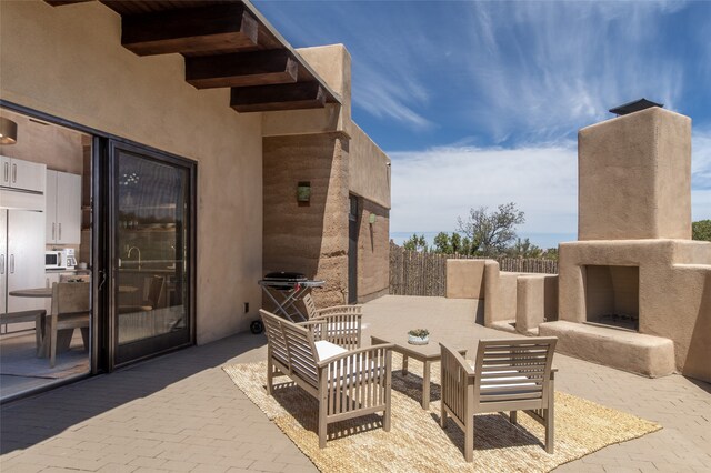 view of patio / terrace featuring an outdoor fireplace