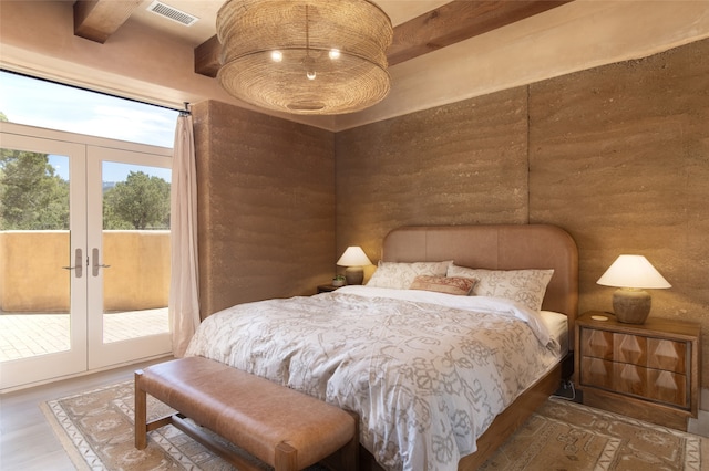 bedroom with french doors, beam ceiling, hardwood / wood-style floors, and access to outside