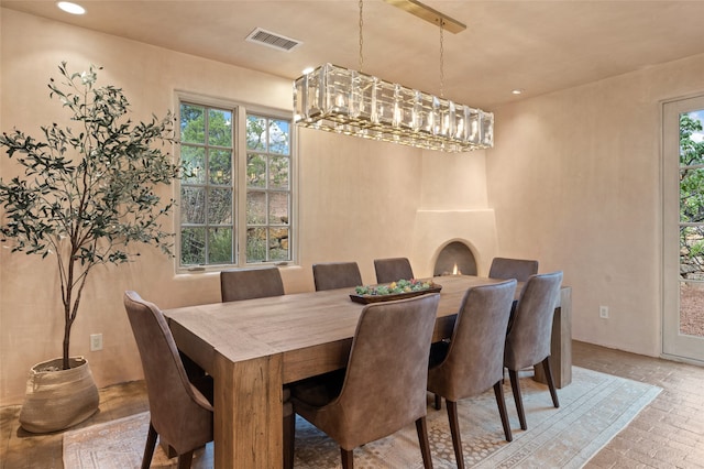 23 Lavadero Rd, Santa Fe, NM 87506 - dining space with a notable chandelier, visible vents, recessed lighting, and brick floor