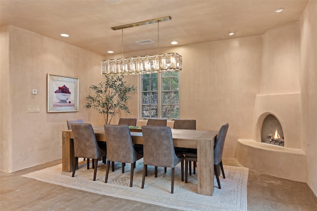 23 Lavadero Rd, Santa Fe, NM 87506 - dining space featuring brick floor, recessed lighting, visible vents, and a chandelier