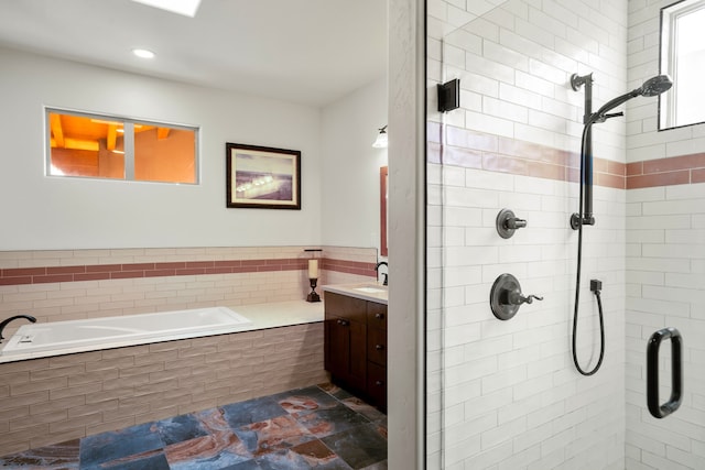 bathroom featuring a shower stall, vanity, and a bath