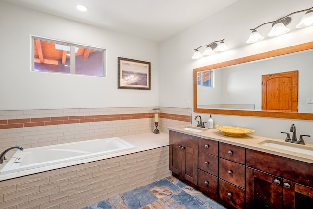 bathroom with double vanity, a sink, and a bath