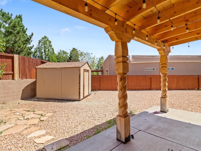 view of patio / terrace featuring a fenced backyard, an outdoor structure, and a storage unit