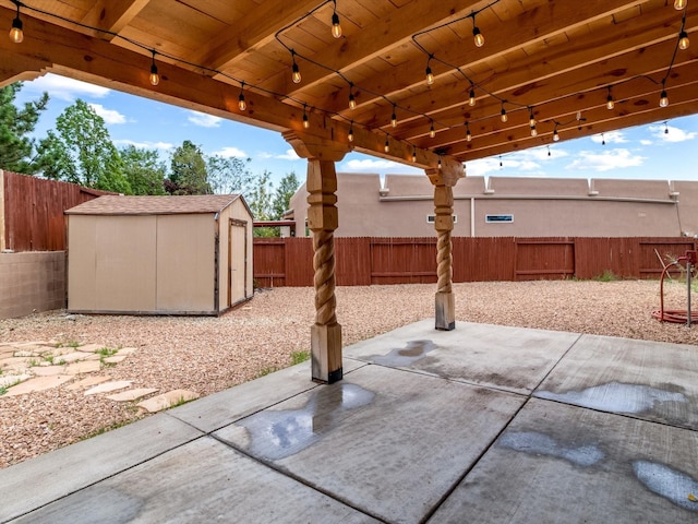 view of patio featuring a fenced backyard, an outdoor structure, and a shed