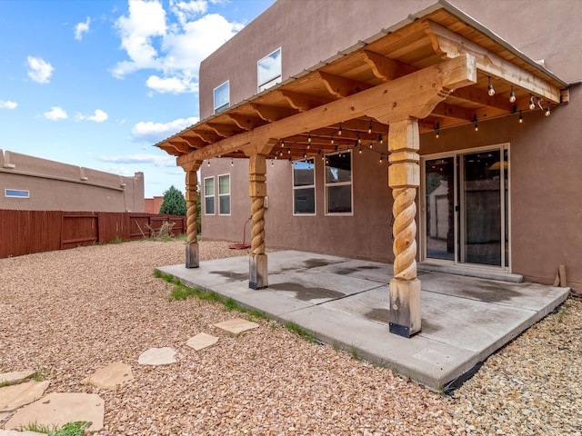 exterior space featuring stucco siding, a patio area, and fence