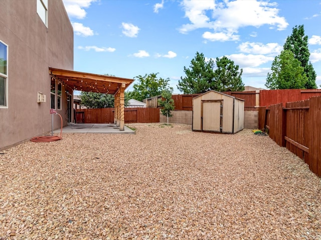 view of yard with a patio area, a fenced backyard, a shed, and an outdoor structure