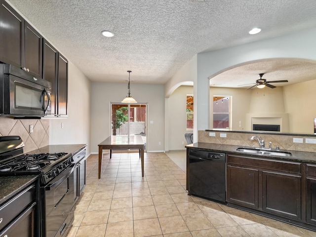 kitchen featuring arched walkways, ceiling fan, a sink, black appliances, and tasteful backsplash