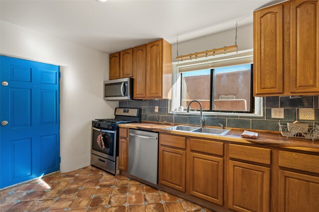 kitchen featuring backsplash, sink, and stainless steel appliances