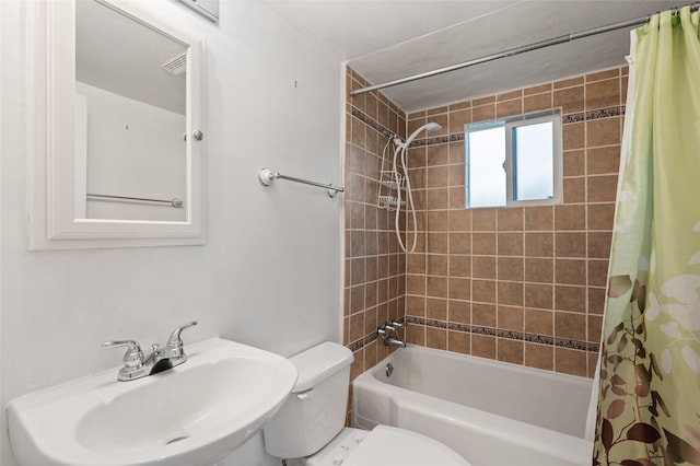 full bathroom featuring shower / bathtub combination with curtain, toilet, and sink