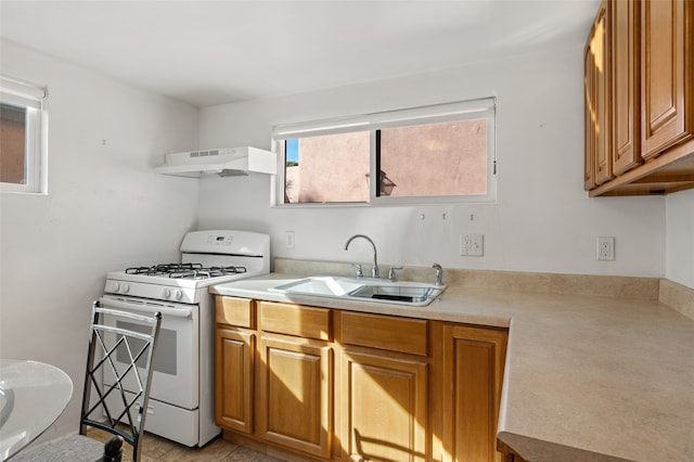 kitchen with ventilation hood, light tile patterned flooring, sink, and white gas range oven